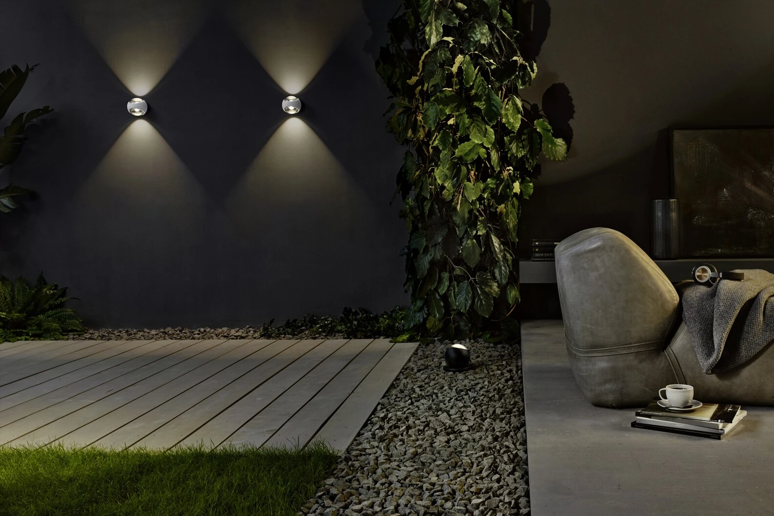 A stylish outdoor area featuring a cozy couch surrounded by a stunning wall of twinkling lights, creating a warm ambiance.